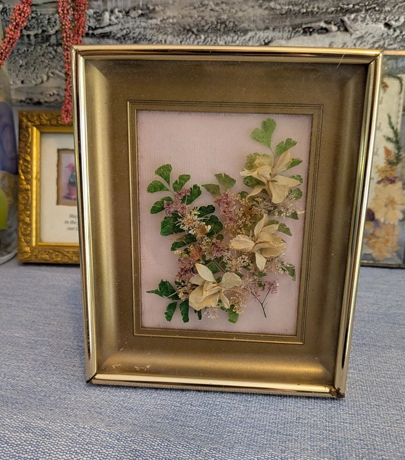 Vintage gold framed pressed flower art with real dried botanicals in floral arrangement