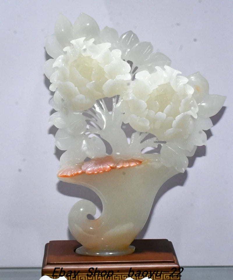 White jade peony flower carving statue with hollow petals and sculpted leaves, on base