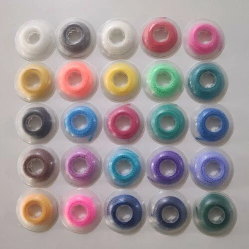 Assorted orthodontic elastic power chain bands in plastic holders, mixed colors