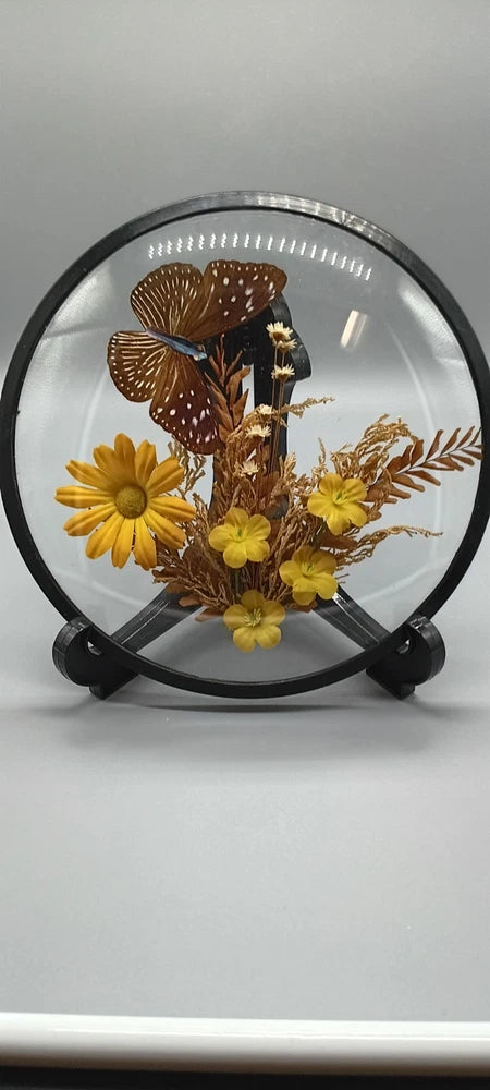 Dome glass display with faux butterfly and yellow dried flower arrangement on stand