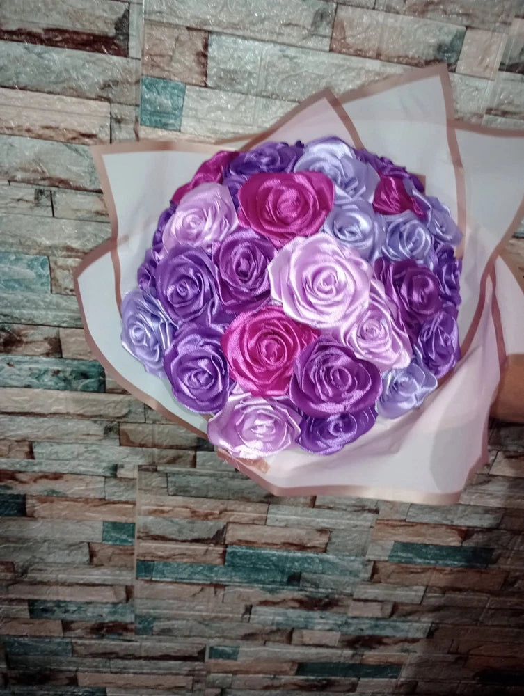 Silk ribbon rose bouquet with purple and pink roses, wrapped in pink paper