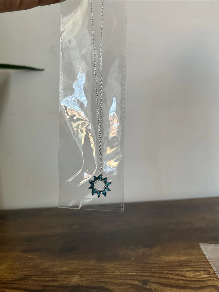Silver-tone necklace with blue sunflower pendant on a fine chain