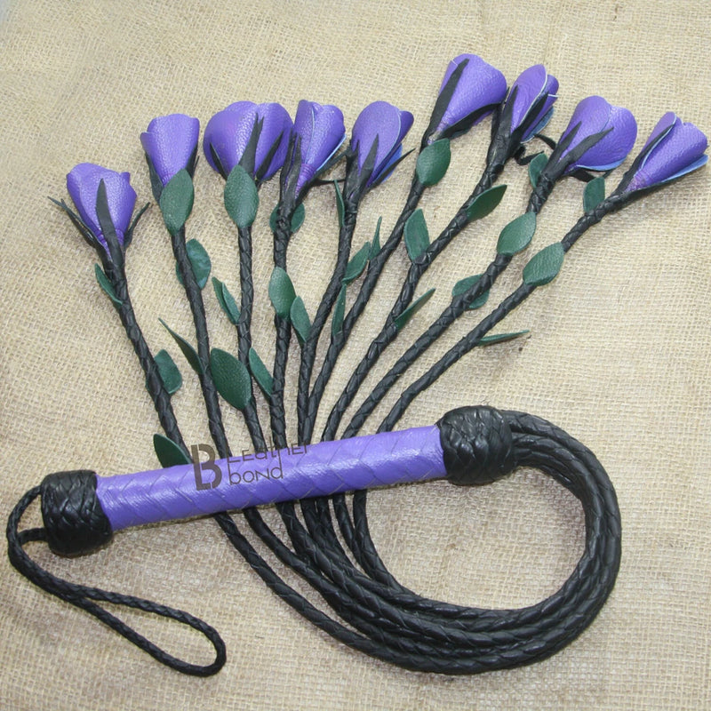 Leather flogger with braided purple handle and black braided falls with loops