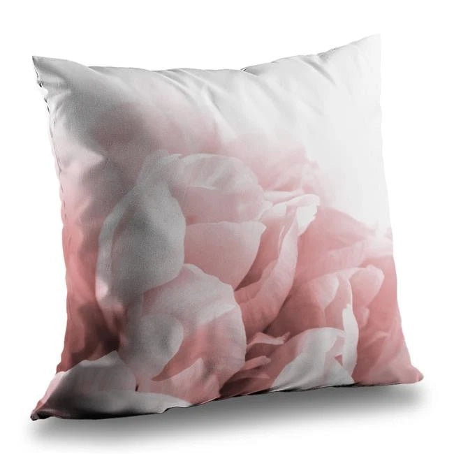 Square throw pillow with pink peony and gray petals print, light background.