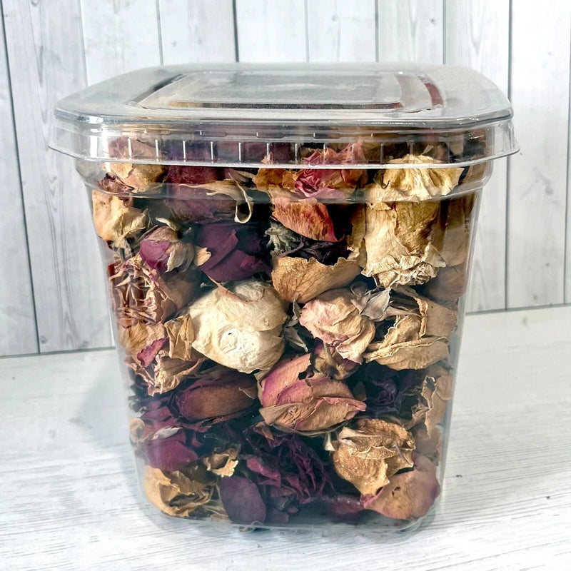 Mixed dried flower petals and buds in a clear plastic jar