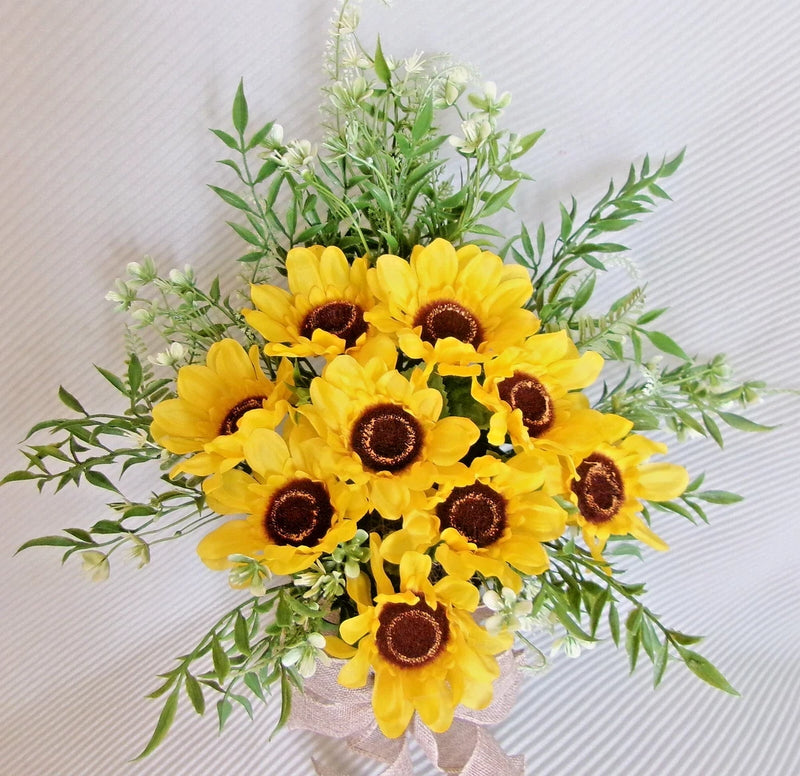 Silk sunflower floral arrangement with yellow blooms, brown centers, and green leafy stems