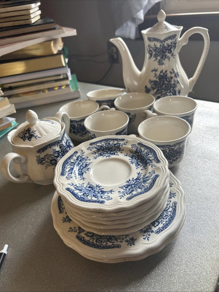 Blue floral tea cups with matching saucers, stacked set on display