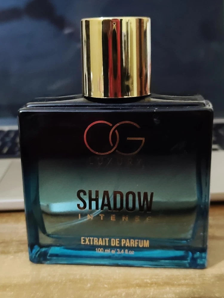 Men's extrait de parfum bottle with gold cap; black and blue gradient label