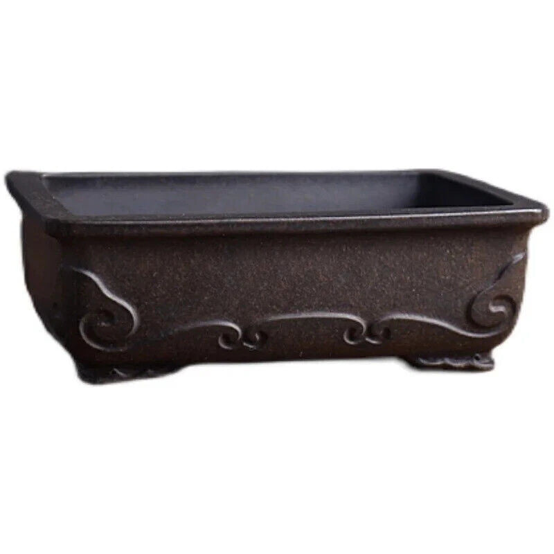 Dark brown ceramic planter pot with scrollwork sides and built-in tray