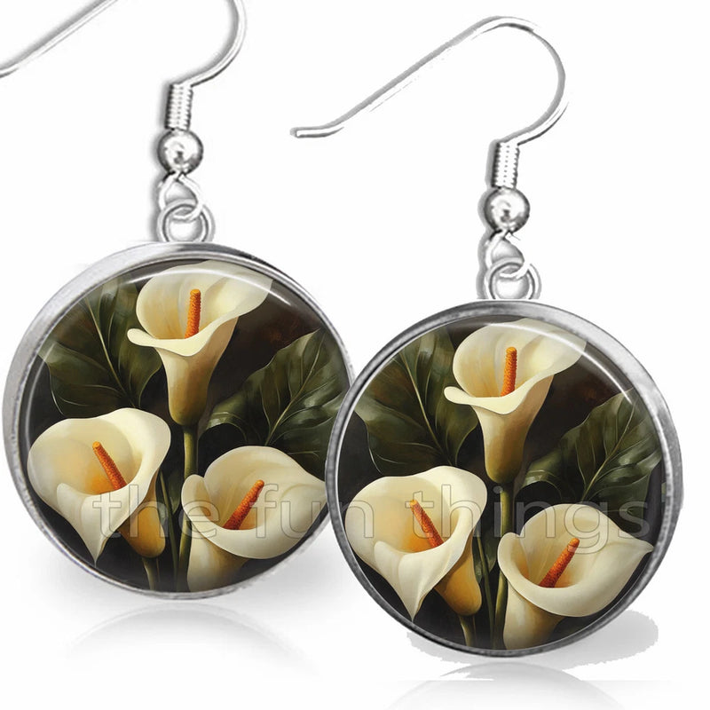 Dangle earrings with round glass cabochons featuring white calla lilies and orange centers