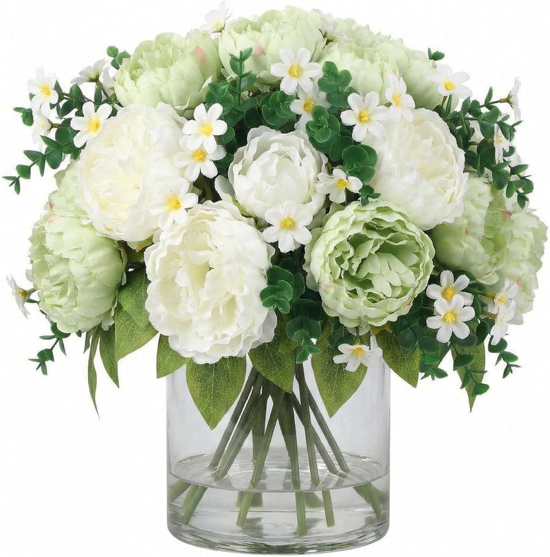 Silk peony bouquet in clear glass vase with white and pale green faux peonies and leaves
