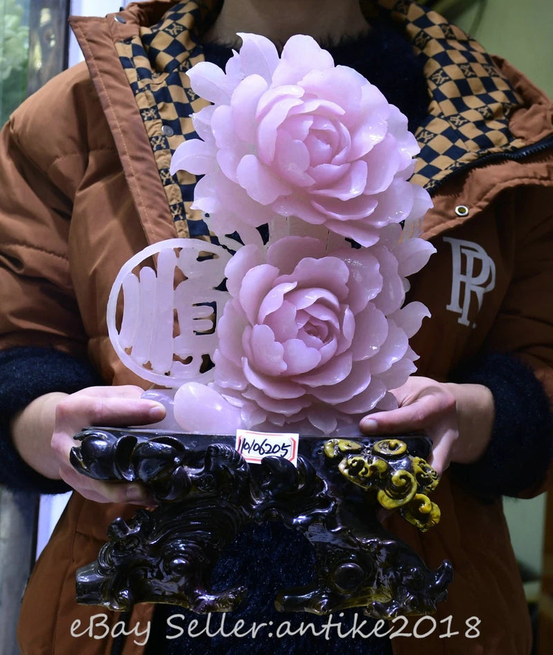 Dark carved peony and bird statue on base, held in hands