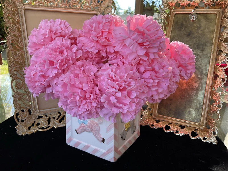 Artificial pink silk carnation picks in a small striped box, flower bunch