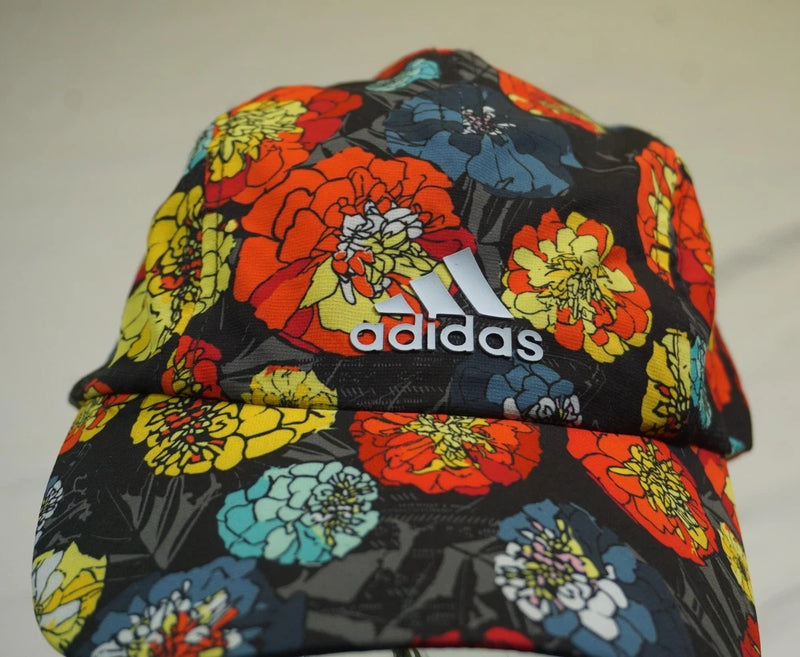 Floral Adidas cycling cap with black base, colorful flowers, and Adidas logo