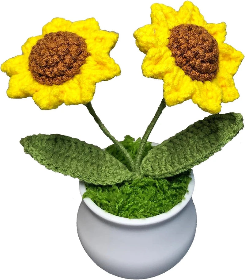 Crocheted sunflower bouquet in a white pot with yellow petals, brown centers, and green leaves