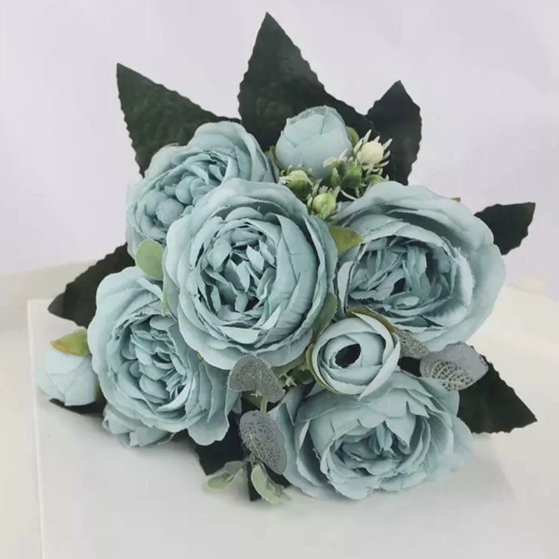 Artificial silk peony bouquet with light blue flowers and green leaves