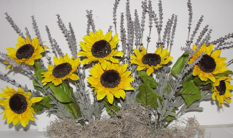 Yellow sunflower and lavender faux floral arrangement in window box with green leaves