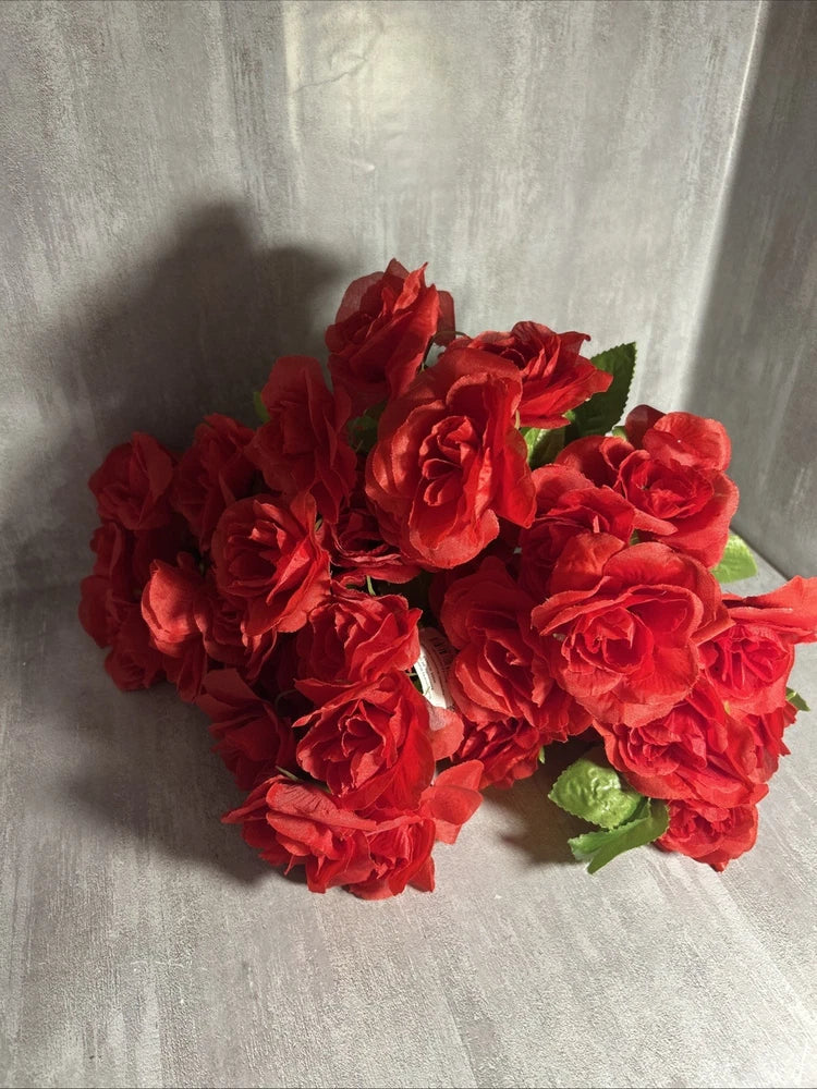 Red artificial rose pick bouquet with layered blooms and green leaves