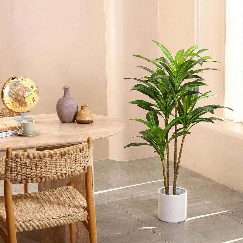 Artificial dracaena plant in white pot with green pointed leaves