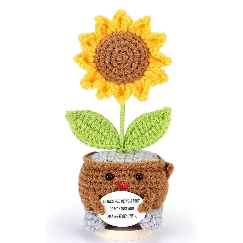 Crocheted sunflower with green leaves, brown base, and an encouraging folded card