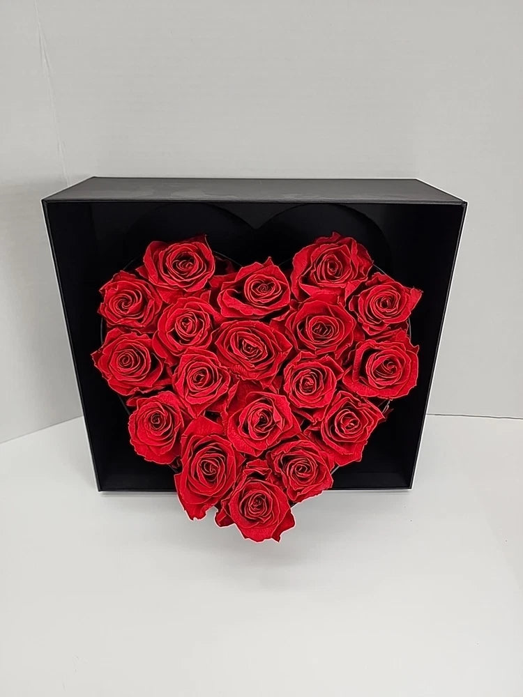 Black luxury gift box with red preserved roses arranged in a heart shape