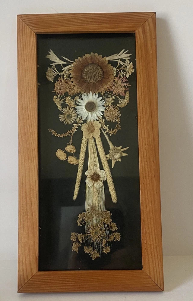 Wood-framed dried floral herbarium with bouquet of daisies and small dried blooms