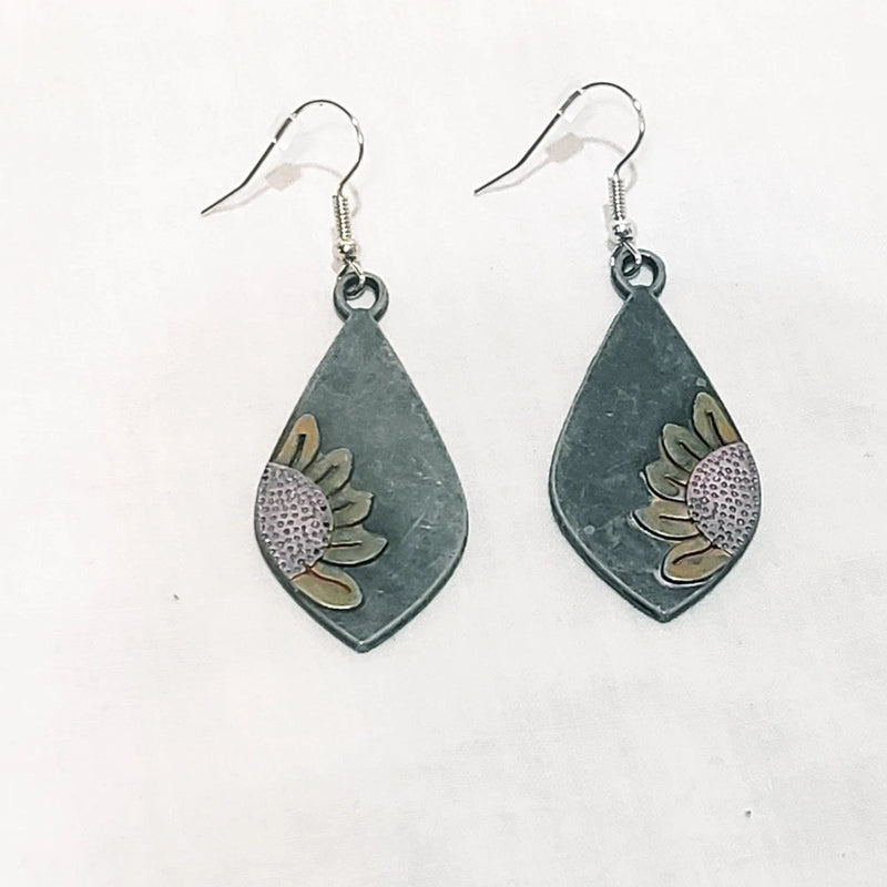 Gray metal teardrop dangle earrings with sunflower leaf cutouts and fishhook backs