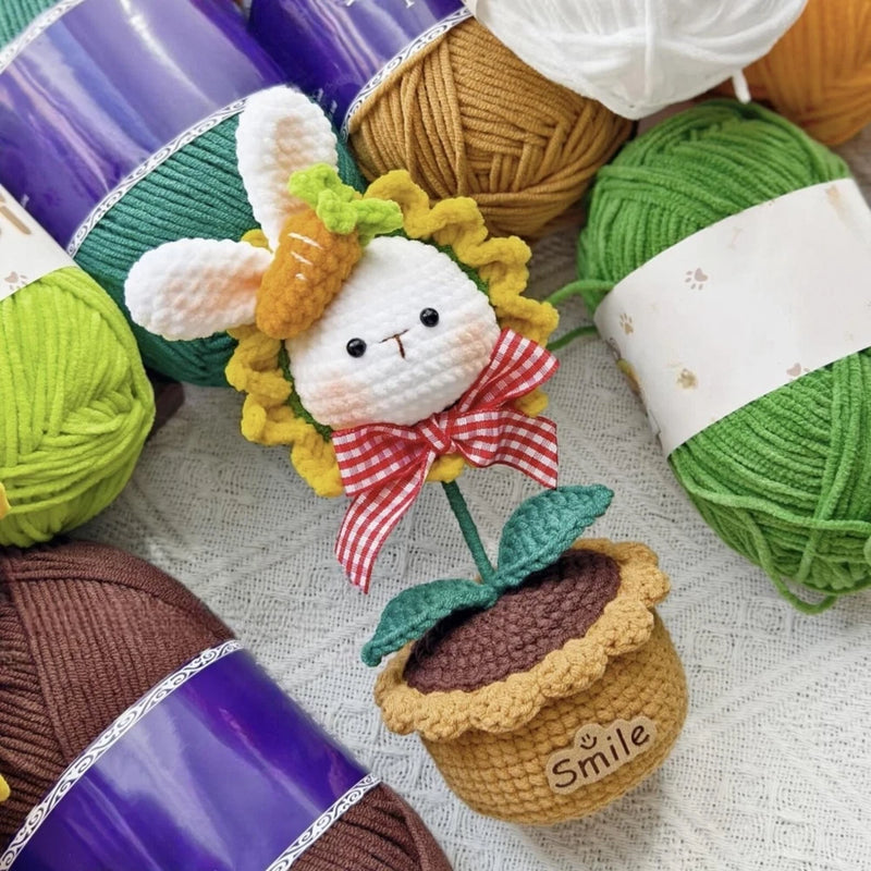 Handmade crochet bunny amigurumi with sunflower, in a small pot, red bow
