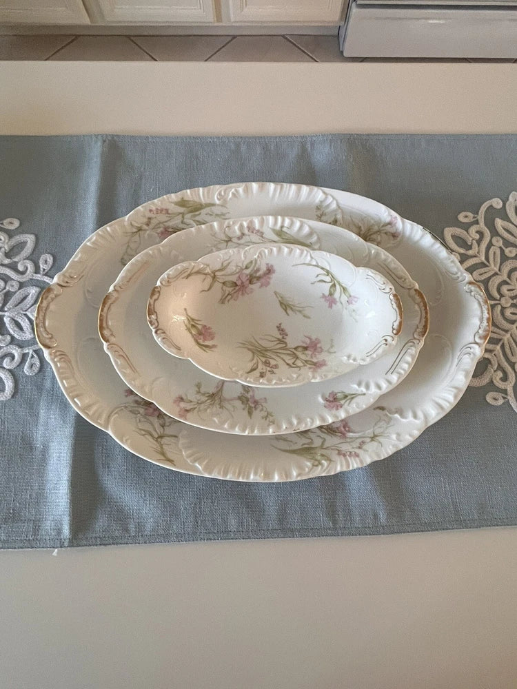Oval porcelain serving platter set with embossed rim and pink floral pattern