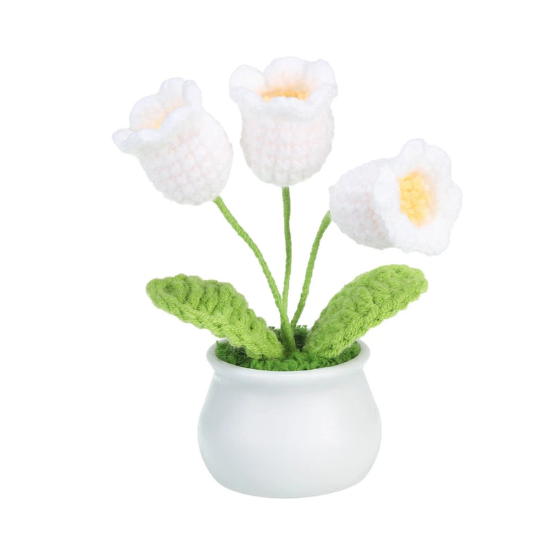 White lily of the valley crochet flowers in small white pot, with green stems and leaves