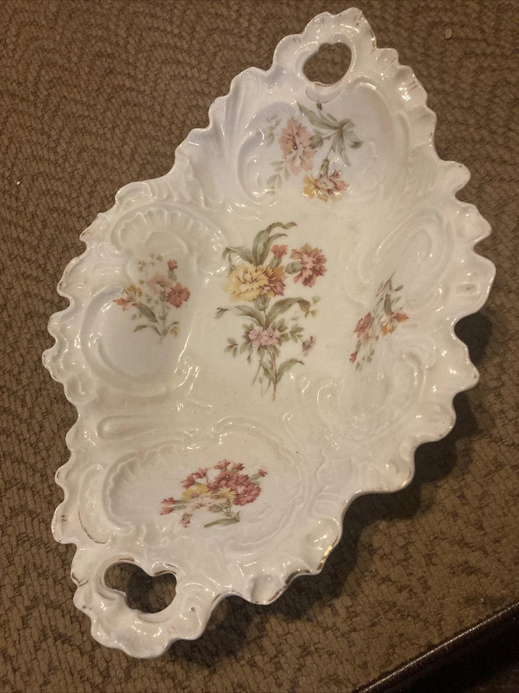 Porcelain serving dish with scalloped edge, floral bouquet design, and gold trim