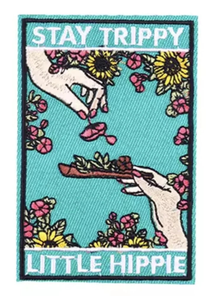 Rectangular embroidered fabric patch, teal, with flower pattern, peace hands, and 'Stay Trippy' text