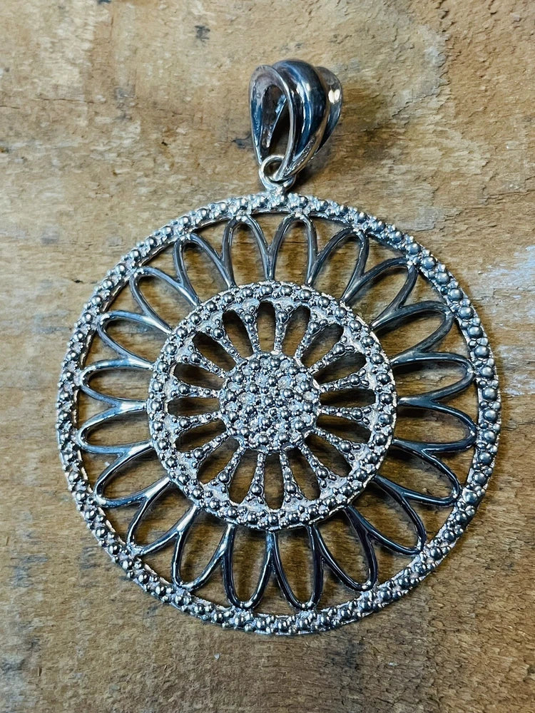 Sterling silver sunflower pendant necklace charm with textured circular petals and loop bail