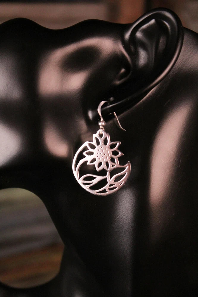 Sterling silver sunflower silhouette dangle earrings on hook with round floral medallion