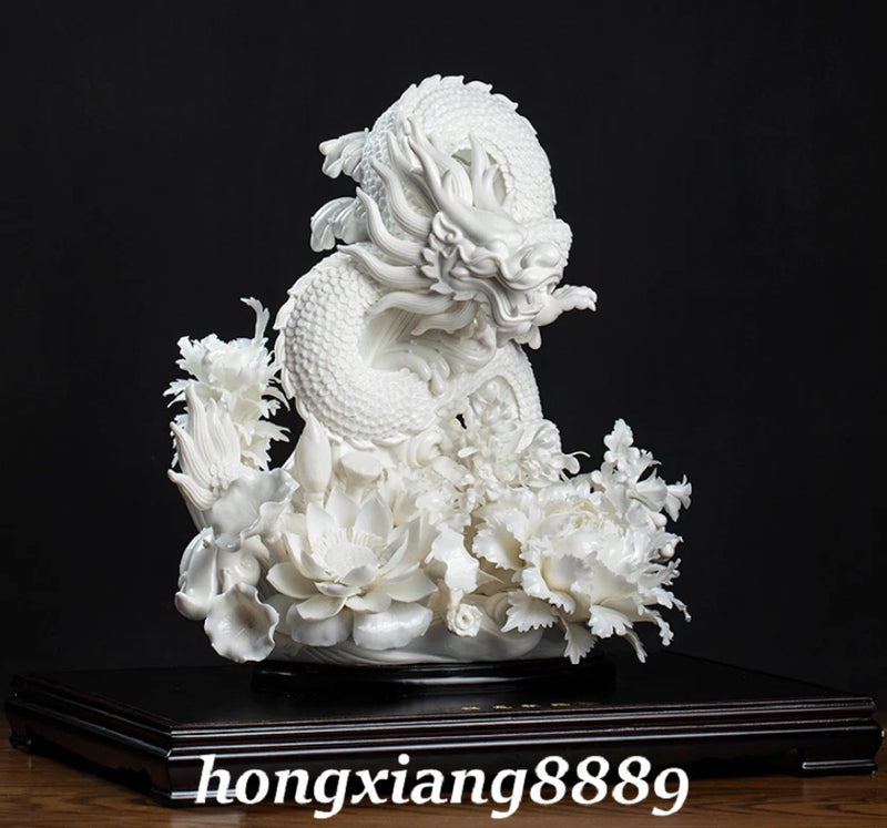 White porcelain dragon-beast statue with peony flowers, detailed relief, on black base