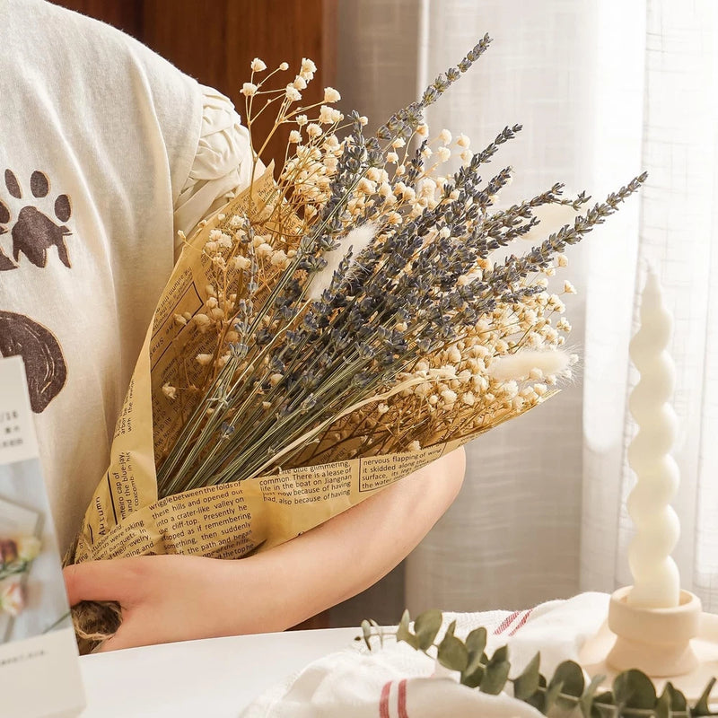 Dried lavender and baby’s breath bouquet in tan and cream, held in hand