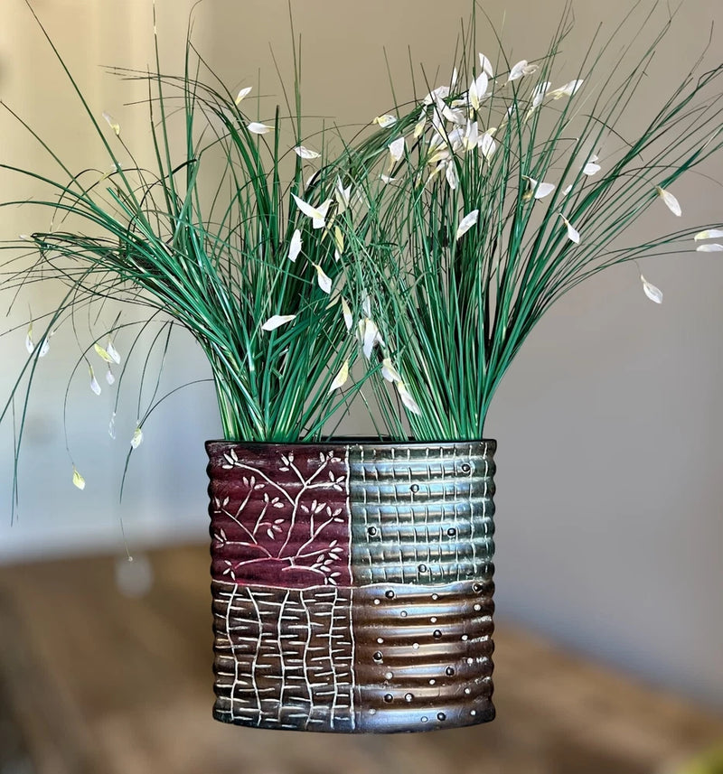 Faux artificial grass plant in stoneware planter with green blades and white accents