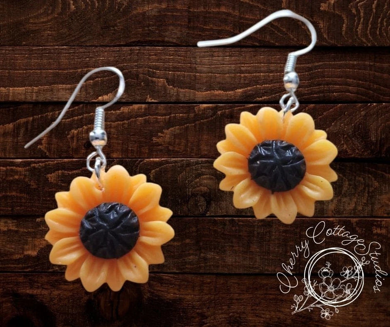 Sunflower dangle earrings with yellow petals and dark centers, silver hooks