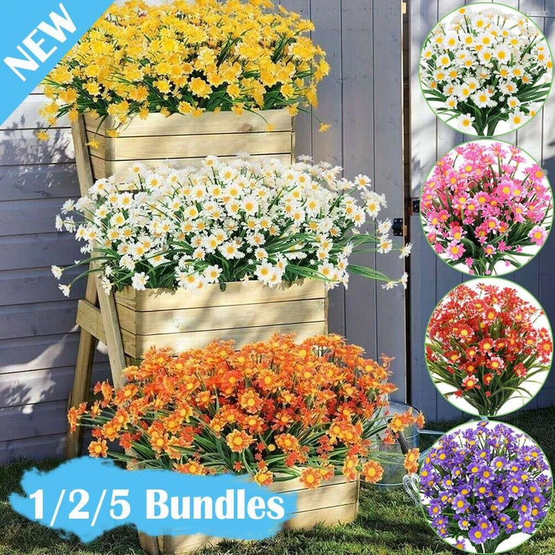 Artificial flower crate display with yellow, white, and orange blossoms and green leaves