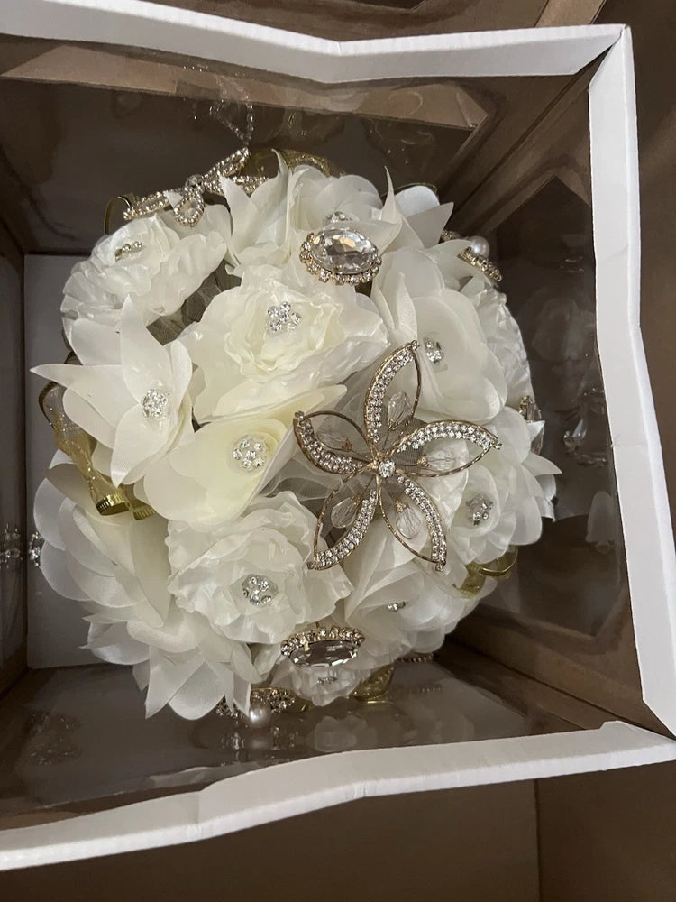 Gold-tone rhinestone brooch bouquet with white fabric flowers and crystal centers