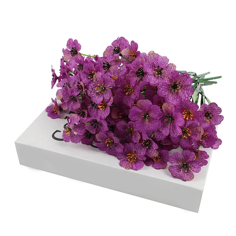 Artificial purple flowering plant with clustered small blooms and green stems