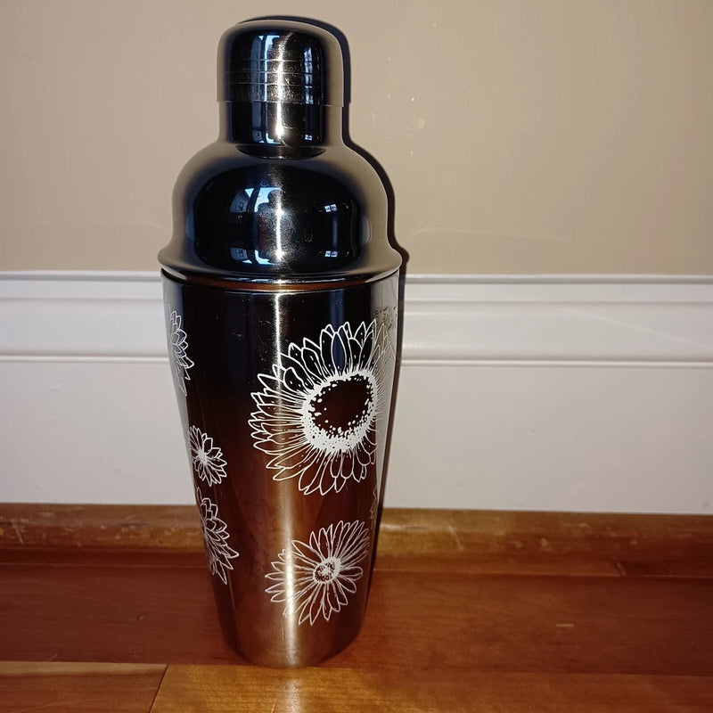 Stainless steel cocktail shaker with black finish and white sunflower target design