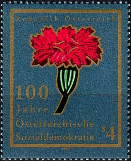 Red carnation flower commemorative postage stamp on blue background, perforated edges.