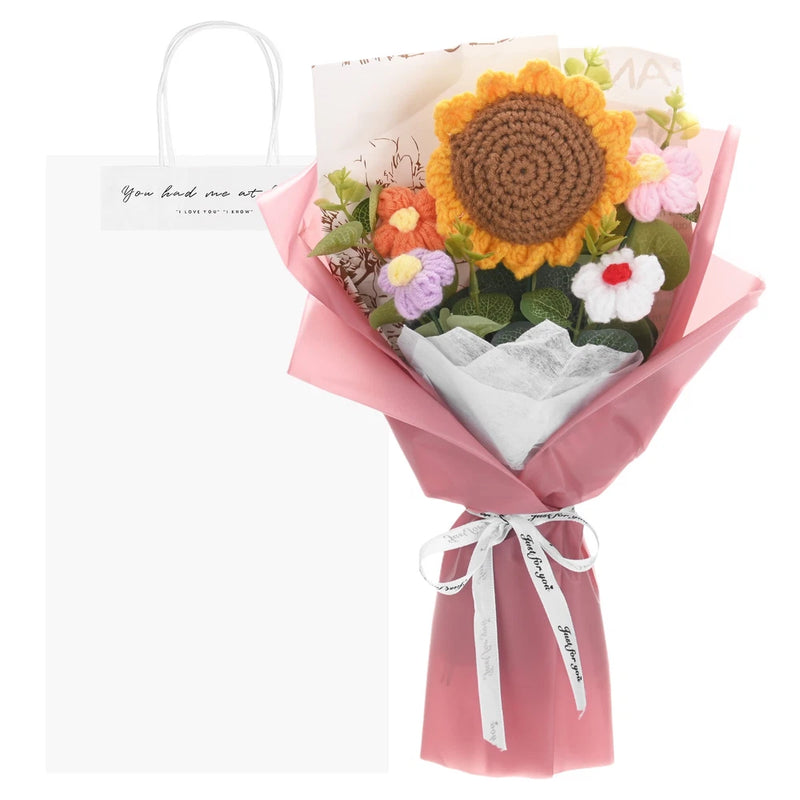 Crochet sunflower bouquet with small flowers in pink wrap and matching gift bag