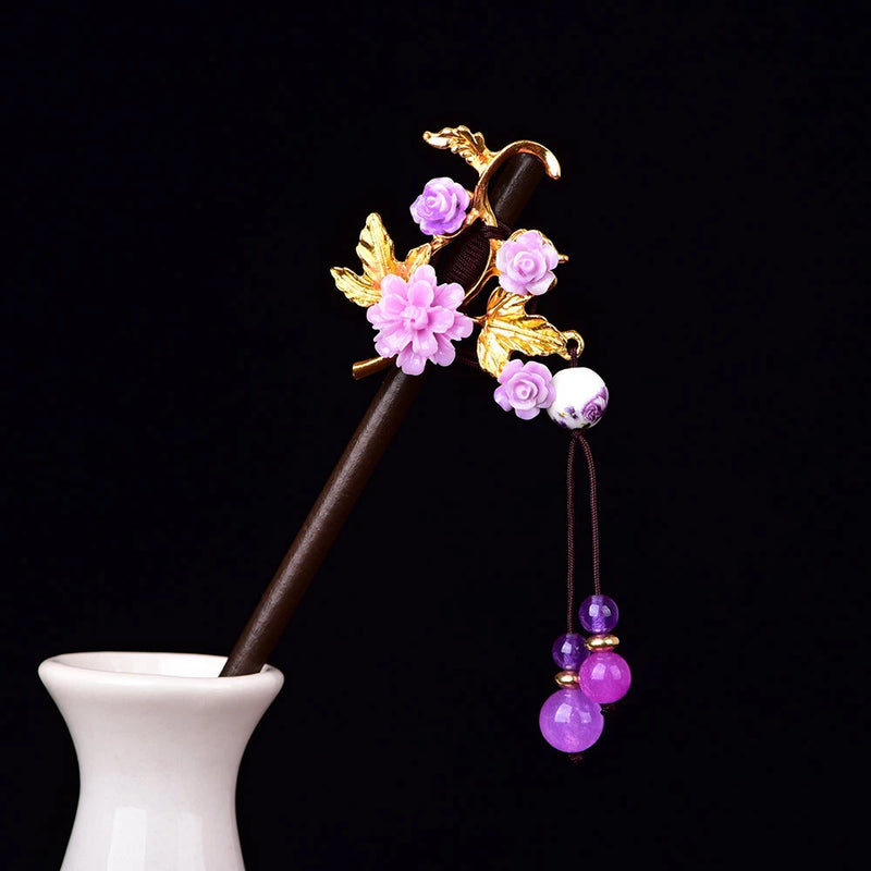 Brown floral hairpin with gold leaves, pink peony flowers, and dangling purple beads