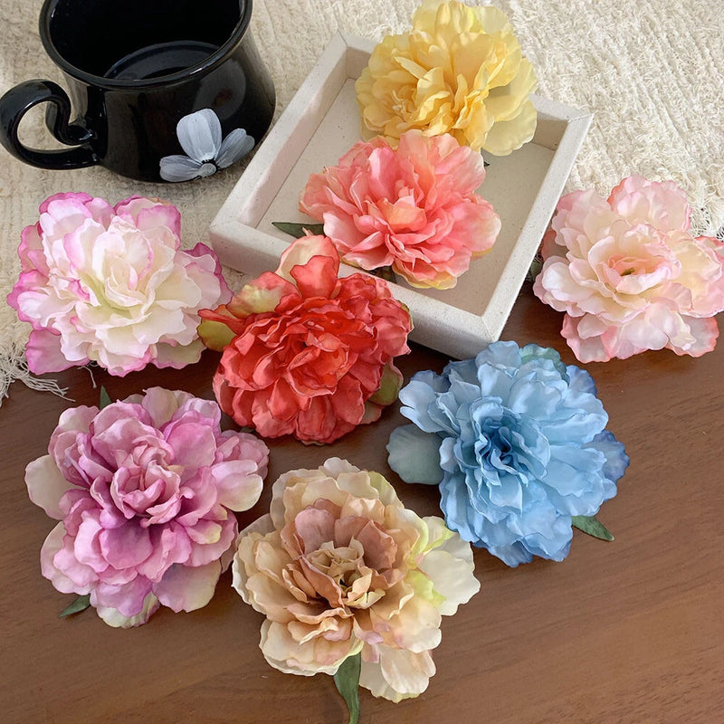 Assorted peony flower hair clips with pastel blooms in pink, coral, blue, and cream