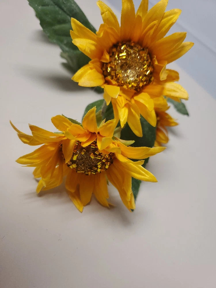 Sunflower stem pick with two bright yellow blooms and green leaves