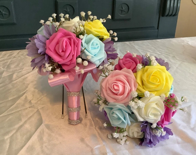 Set of 2 wedding bouquets with pink, yellow, light blue, and purple roses and baby's breath