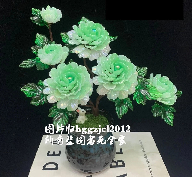 Green peony flower bonsai centerpiece in a small gray pot with leaf accents