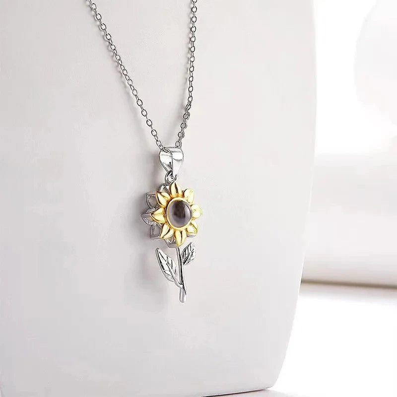 Silver-tone sunflower pendant necklace with yellow petals and dark center stone